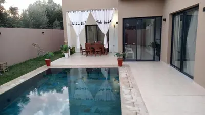 a swimming pool in the backyard of a house at Villa jama in Marrakech