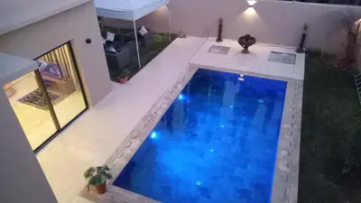 an overhead view of a large blue swimming pool at Villa jama in Marrakech