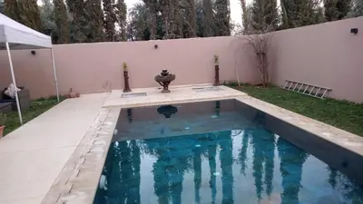 a swimming pool in the backyard of a house at Villa jama in Marrakech