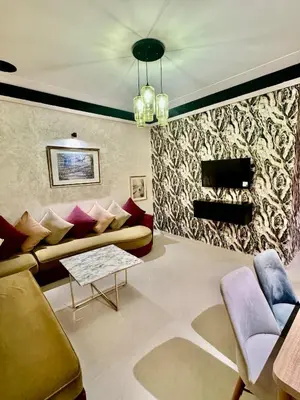 a living room with a couch and a table at Apartment, well equipped in Fès