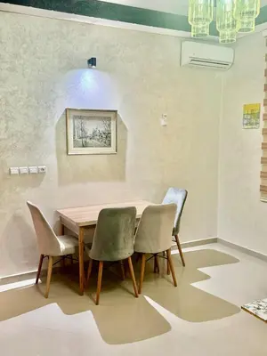 a dining room with a wooden table and chairs at Apartment, well equipped in Fès