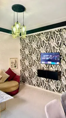 a living room with a tv on a wall at Apartment, well equipped in Fès