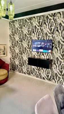 a living room with a wall with a tv on it at Apartment, well equipped in Fès