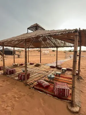 a tent in the middle of the desert at Gnaoua Luxury Camp in Merzouga