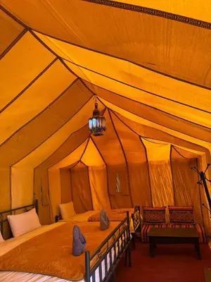 a large tent with a bed in it at Happy luxury camp in Merzouga