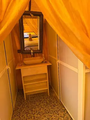 a bathroom with a sink and a mirror at Happy luxury camp in Merzouga