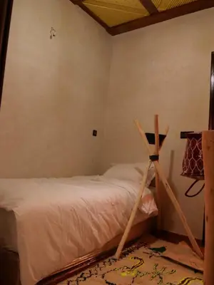 a bed with a wooden frame in a room at Refuge Comfort and Rustic Charm in Anammer