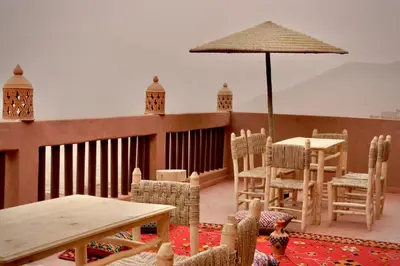 a patio with tables and chairs and an umbrella at Refuge Comfort and Rustic Charm in Anammer