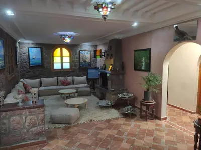 a living room with a couch and a table at Auberge laurier rose in Ourika