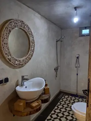 a bathroom with a sink and a toilet and a mirror at Auberge laurier rose in Ourika