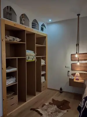 a room with a closet with wooden shelves at Auberge laurier rose in Ourika