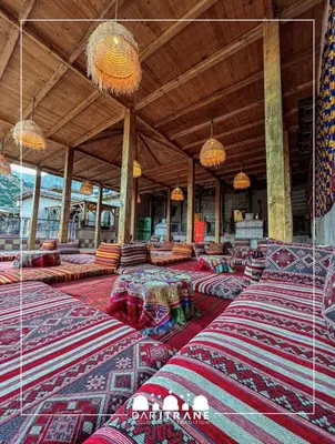 a large room with lots of tables and pillows at Ecolodge Dar itran in Azilal