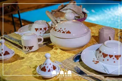 a table topped with bowls and cups on a table at Ecolodge Dar itran in Azilal