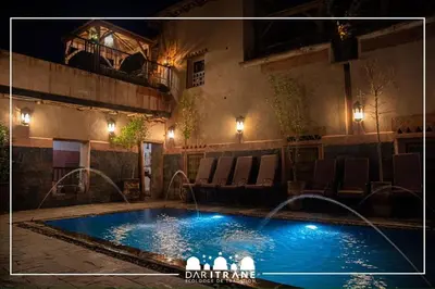 a swimming pool in a yard at night at Ecolodge Dar itran in Azilal