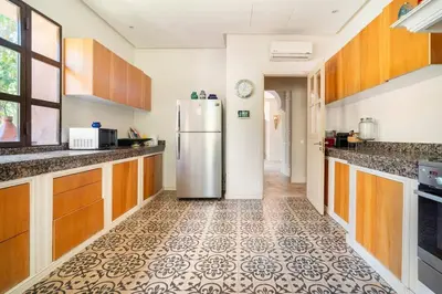 a kitchen with a refrigerator in the middle of it at Luxury Villa Marrakech - Heated Pool in Najem