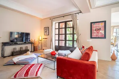 a living room with a red couch and a table at Luxury Villa Marrakech - Heated Pool in Najem