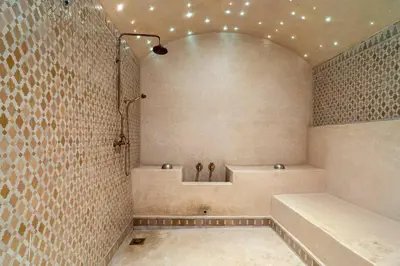 a bathroom with a tub and a shower with lights at Luxury Villa Marrakech - Heated Pool in Najem