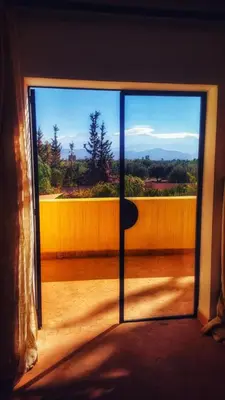 a sliding glass door with a view of a balcony at Dar Muezza in Marrakech
