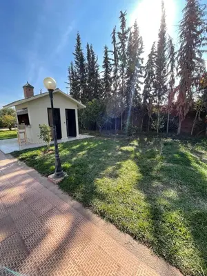 a house with a street light in the grass at Deluxe private villa in Marrakech