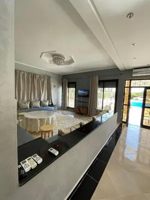a living room with a bed and a table at Deluxe private villa in Marrakech
