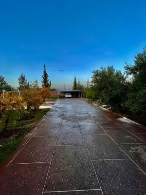 an empty road with a car parked on it at Deluxe private villa in Marrakech