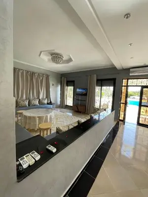 a living room with a pool table in the middle at Deluxe private villa in Marrakech