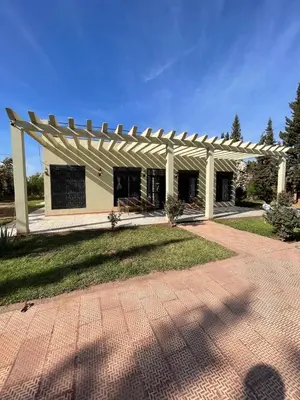 a white building with a wooden pergola at Deluxe private villa in Marrakech