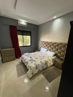a bedroom with a large bed and a window at Deluxe private villa in Marrakech