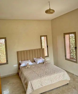 two stuffed animals sitting on a bed in a bedroom at Villa Bellevue Marrakech in Sbiti