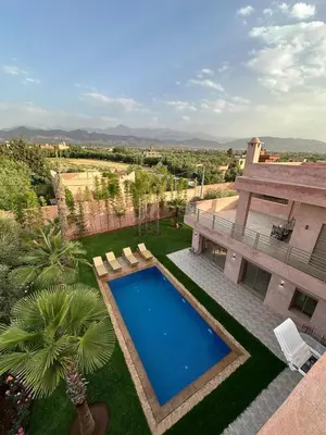 an aerial view of a house with a swimming pool at Villa Bellevue Marrakech in Sbiti