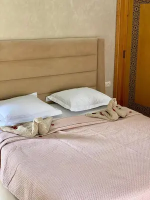 a bedroom with two beds with towels on them at Villa Bellevue Marrakech in Sbiti