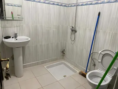 a bathroom with a shower and a toilet and a sink at شقة للكراء اليومي in Azrou