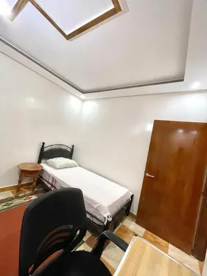 a small room with a bed and a door at Red Stone Appartement in Midelt