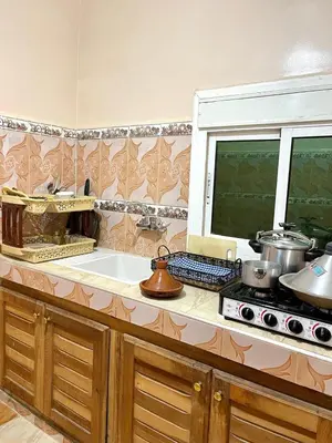a kitchen with a stove and a counter top at Red Stone Appartement in Midelt