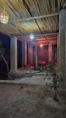 a room with a table and chairs in it at Dar Tamzdamte Skoura in Skoura