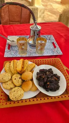 a tray with a plate of food on a table at Dar Tamzdamte Skoura in Skoura