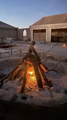 a fire pit in the middle of a parking lot at Marruecos Excursiones Camp in Mezguida