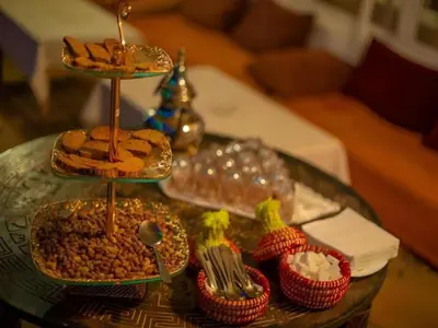 a glass table topped with different types of food at Merzouga Sahara Top Camp in Merzouga
