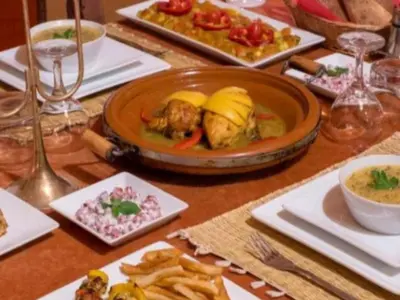 a table with a plate of food on a table at Merzouga Sahara Top Camp in Merzouga