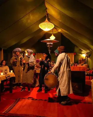 a group of people standing in a room with a drum at Merzouga Sahara Top Camp in Merzouga