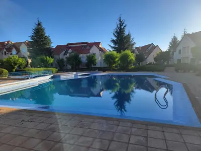 a swimming pool in a yard with houses at Chalet Haut standing pour les familles seulement in Ifrane