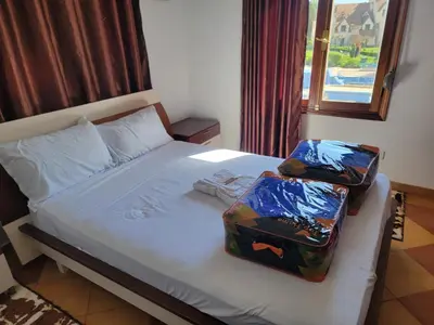 two suitcases sitting on a bed in a bedroom at Chalet Haut standing pour les familles seulement in Ifrane