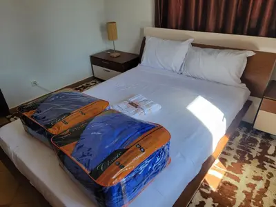 two bags of luggage sitting on a bed at Chalet Haut standing pour les familles seulement in Ifrane