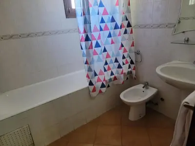 a bathroom with a sink and a toilet and a shower curtain at Chalet Haut standing pour les familles seulement in Ifrane