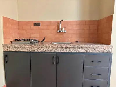 a kitchen with a sink and a counter top at Complexe Kariat Ayoub in Aït Zat