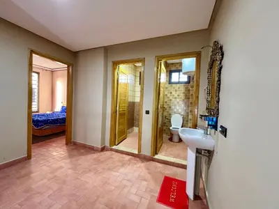 a bathroom with a sink and a shower and a toilet at Complexe Kariat Ayoub in Aït Zat