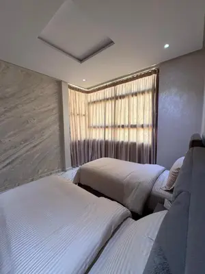 a bedroom with two beds and a window at Oasis deluxe in Fès