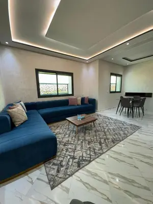 a living room with a blue couch and a table at Oasis deluxe in Fès