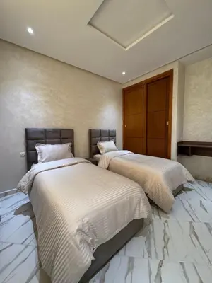two beds sitting next to each other in a bedroom at Oasis deluxe in Fès