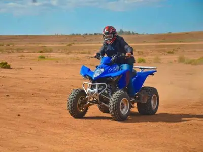 a man riding a four wheeler in the desert at Hacienda Joud Marrakech-Safi in Ben Bouih